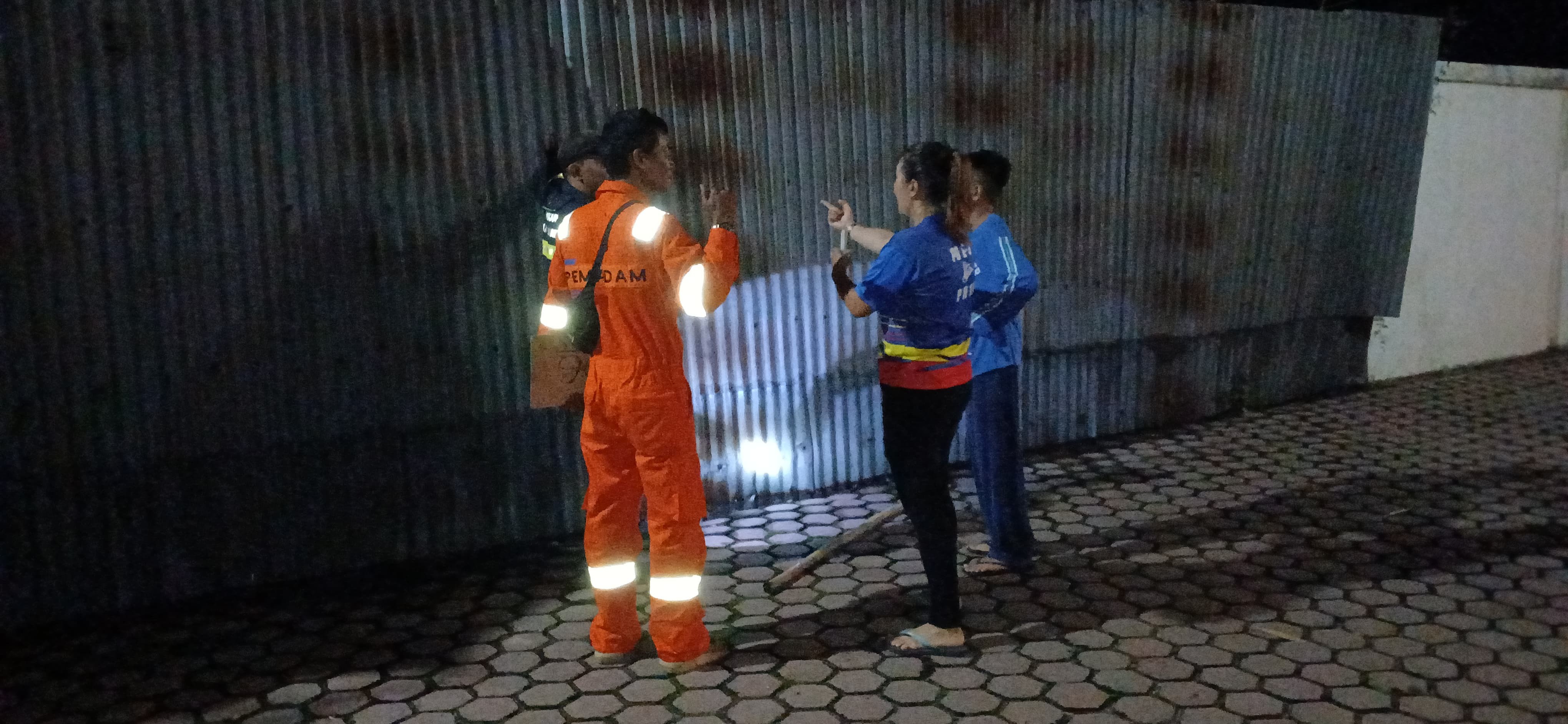 Personil Dinas Pemadam Kebakaran dan Penyelamatan menerima aduan warga mengenai pagar seng yg roboh 
