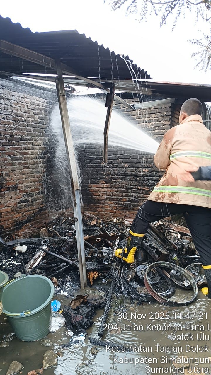 Personil Dinas Pemadam Kebakaran dan Penyelamatan melaksanakan pemadaman kebakaran rumah di Jl. Med