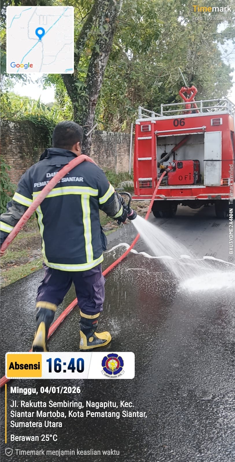 Personil Dinas Pemadam Kebakaran dan Penyelamatan melaksanakan penyiraman jalan yang tertumpah solar